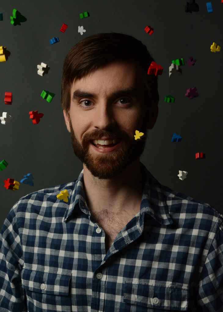 David smiling into the camera, with meeples raining down