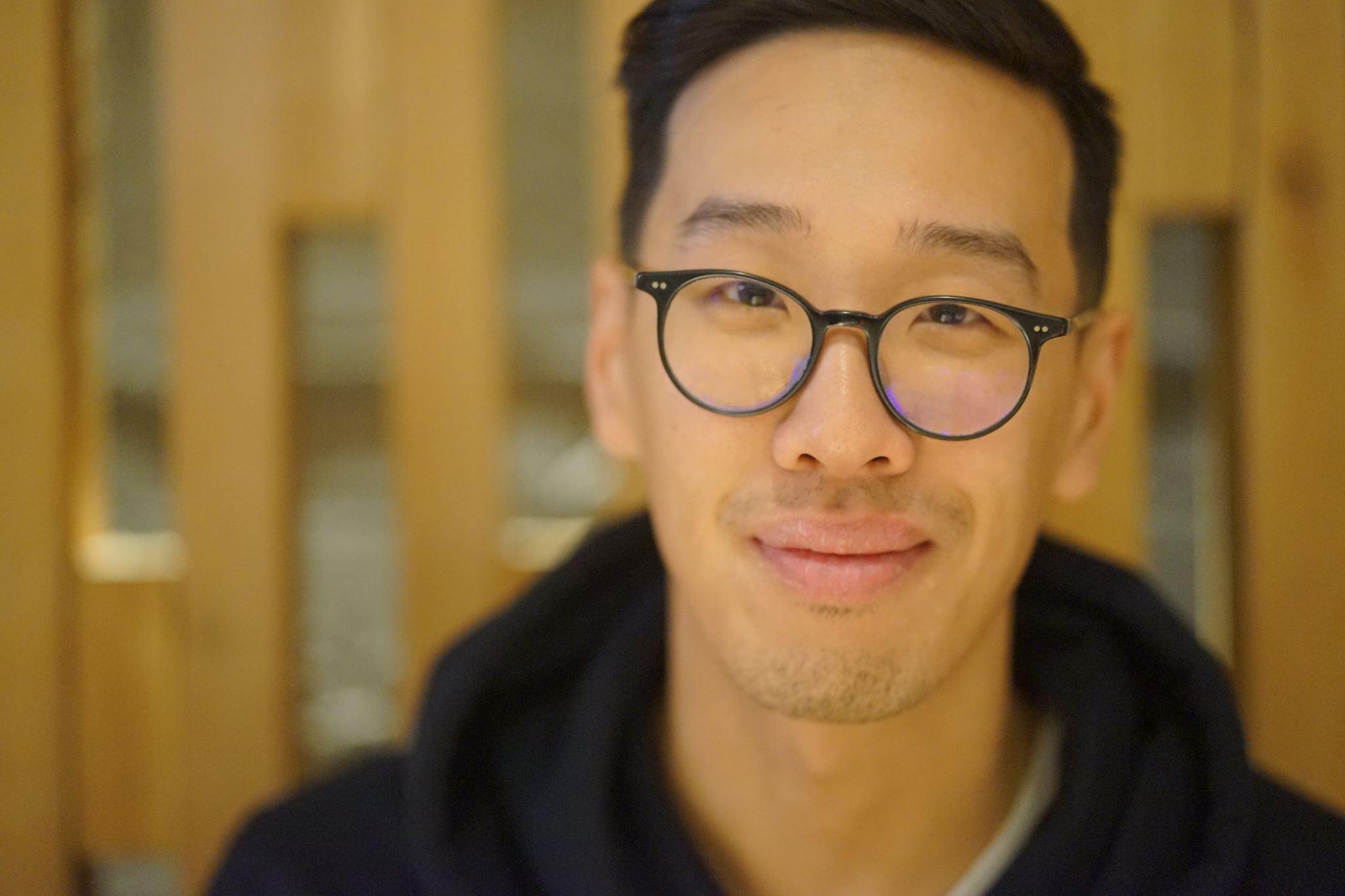Daniel Kwan, wearing a hoodie and smiling at the camera