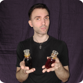 Kurt Refling holding two flasks.