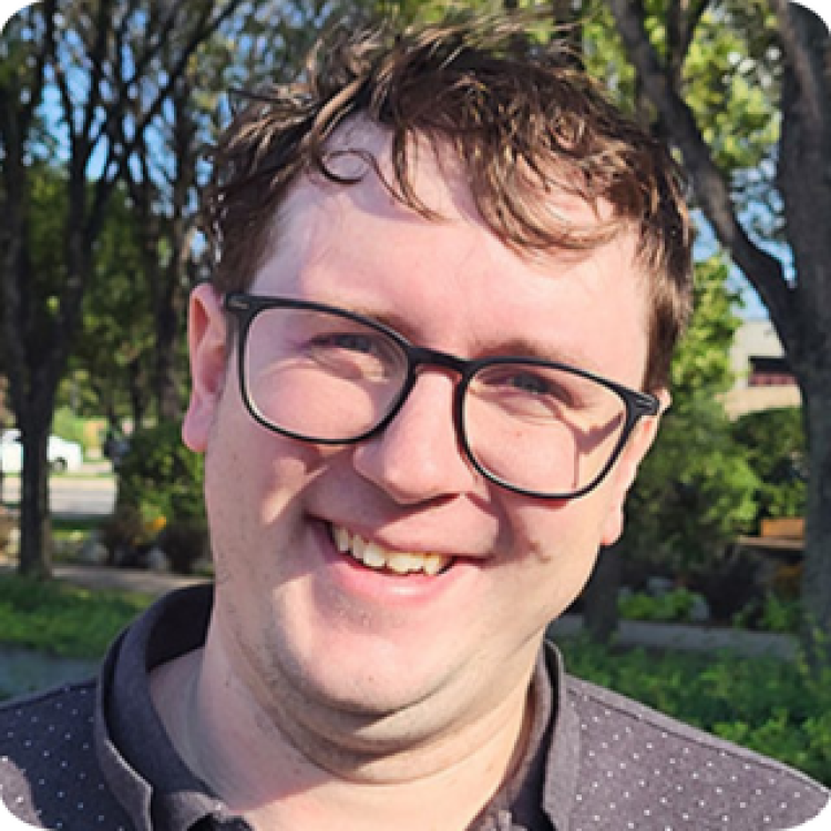 A headshot of Colton Balske standing outside in front of trees.