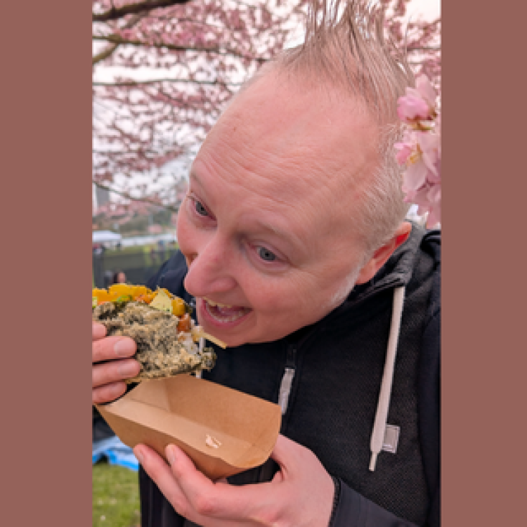 Photo of Christoph Sapinksy eating something delicious.